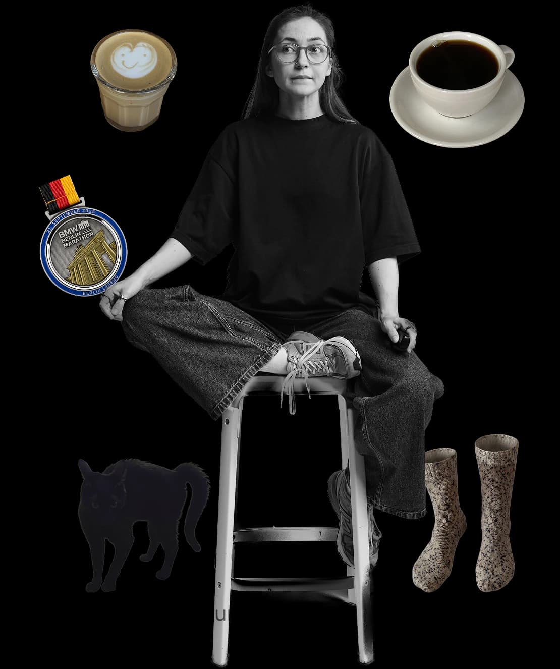 Viktoriia sitting on a stool, surrounded by a latte, a cup of black coffee, her Berlin Marathon medal, her black cat Luna and hand-knitted socks